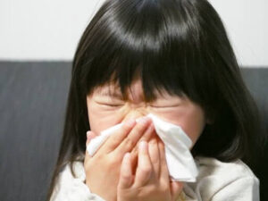 kid blowing nose
